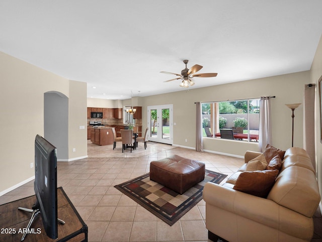 981 N Quail Ln, Gilbert, AZ 85233 - living area featuring light tile patterned flooring, ceiling fan, arched walkways, recessed lighting, and a chandelier