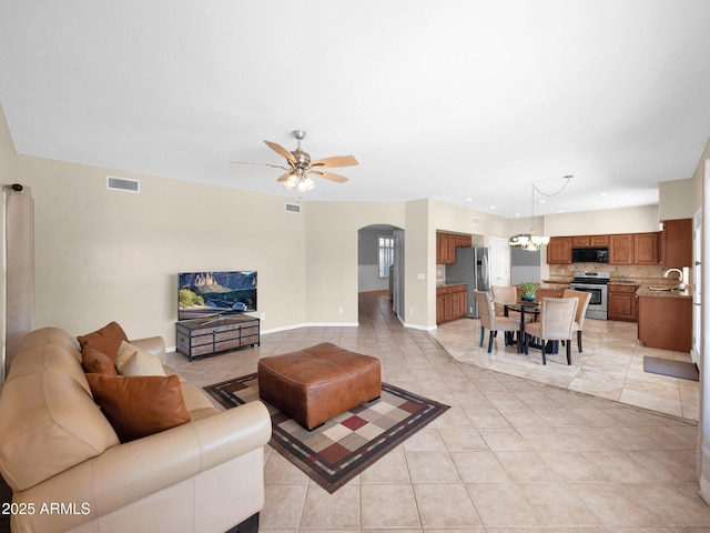 981 N Quail Ln, Gilbert, AZ 85233 - living room with arched walkways, a ceiling fan, light tile patterned floors, a chandelier, and recessed lighting