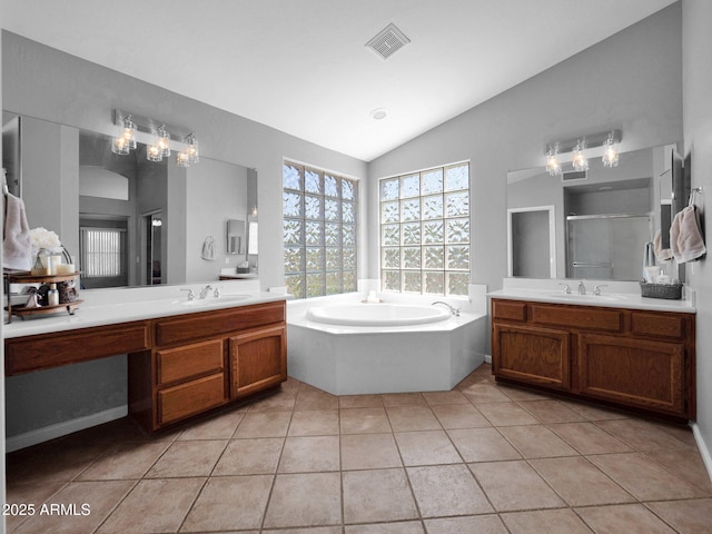 981 N Quail Ln, Gilbert, AZ 85233 - bathroom with lofted ceiling, a shower stall, a bath, two vanities, and tile patterned floors
