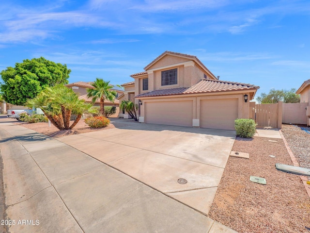 981 N Quail Ln, Gilbert, AZ 85233 - mediterranean / spanish-style house with concrete driveway, stucco siding, a tile roof, and a garage