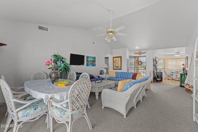 carpeted dining room featuring ceiling fan and vaulted ceiling