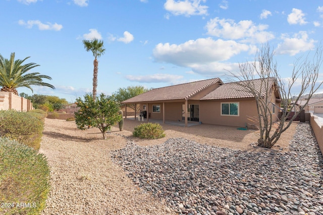 rear view of property featuring a patio area