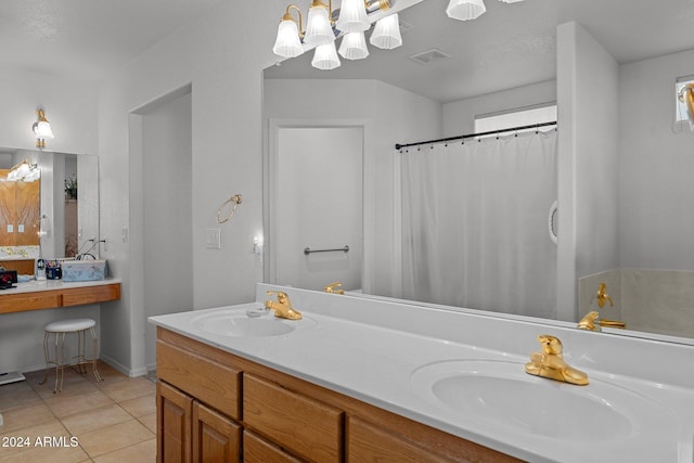 bathroom with tile patterned floors, curtained shower, vanity, and an inviting chandelier