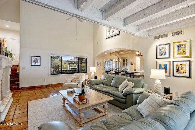 tiled living room with beamed ceiling, ceiling fan, and wooden ceiling