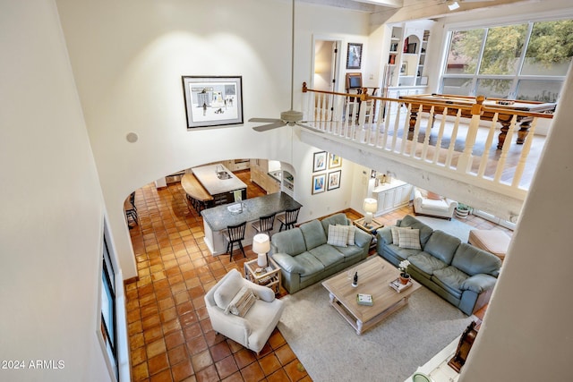 tiled living room featuring ceiling fan