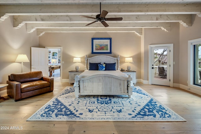 bedroom with beamed ceiling, light hardwood / wood-style floors, a crib, and ceiling fan