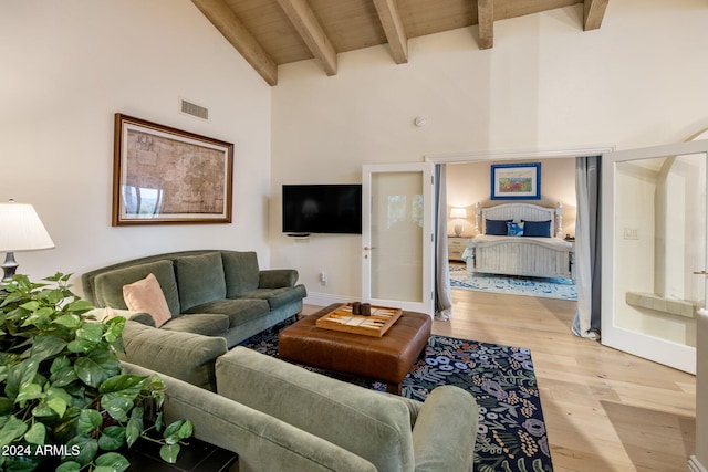 living room featuring french doors, beam ceiling, high vaulted ceiling, wooden ceiling, and light hardwood / wood-style floors