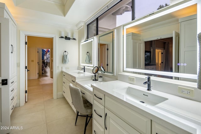 bathroom with tile patterned floors, vanity, crown molding, and a tray ceiling