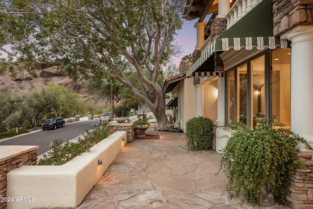 view of patio terrace at dusk