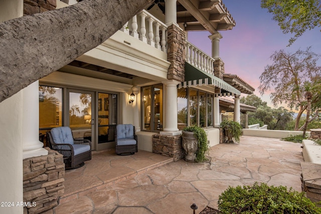 view of patio terrace at dusk