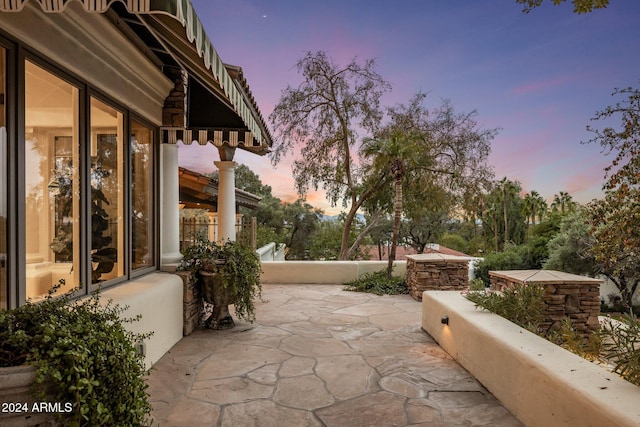 view of patio terrace at dusk