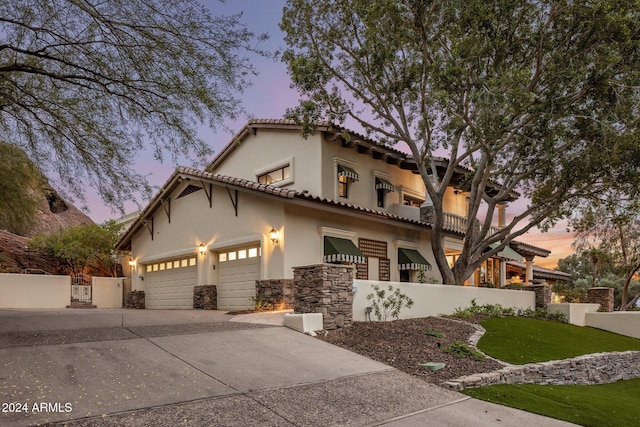 mediterranean / spanish house with a balcony and a garage