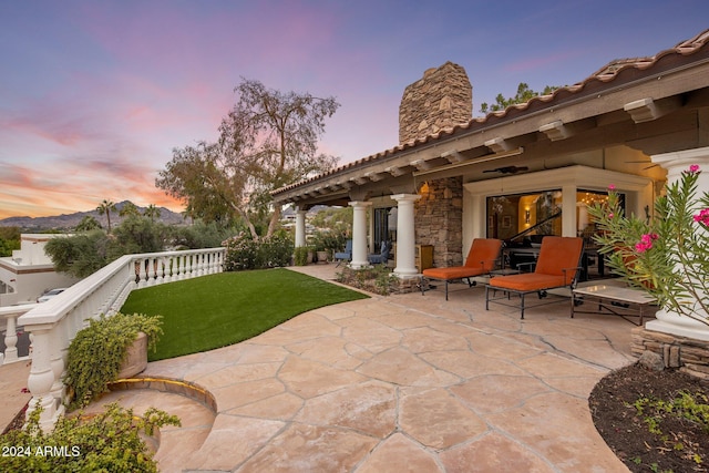 patio terrace at dusk with a lawn