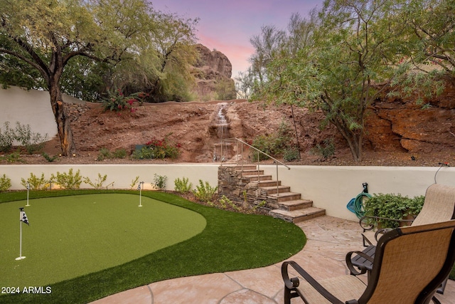 yard at dusk with a patio