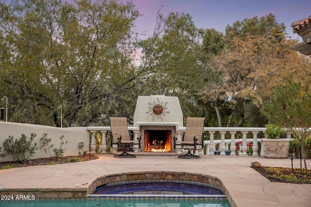 exterior space with a patio and an outdoor fireplace