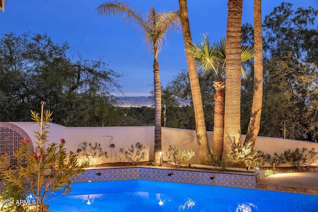 view of pool at dusk