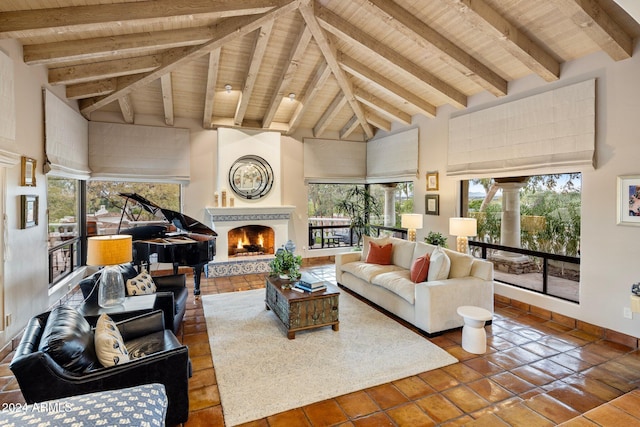 tiled living room with beamed ceiling, wood ceiling, a fireplace, and high vaulted ceiling