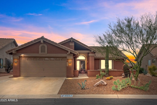 5552 S Feather Bush Ct, Gold Canyon, AZ 85118 - view of front of house featuring a tiled roof, an attached garage, stucco siding, and concrete driveway