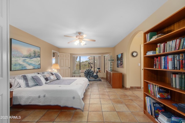 5552 S Feather Bush Ct, Gold Canyon, AZ 85118 - bedroom featuring arched walkways, access to exterior, light tile patterned floors, and ceiling fan