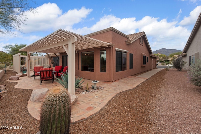 5552 S Feather Bush Ct, Gold Canyon, AZ 85118 - back of property with a mountain view, a pergola, fence, a patio, and stucco siding