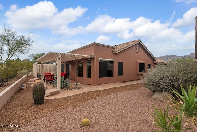 5552 S Feather Bush Ct, Gold Canyon, AZ 85118 - back of property with a tiled roof, a patio area, a pergola, and stucco siding