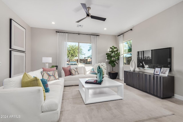 living room with light colored carpet and ceiling fan