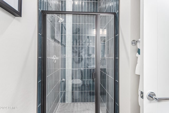 bathroom with a shower with shower door