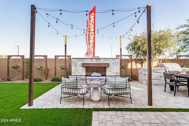 view of patio / terrace featuring an outdoor kitchen and a grill