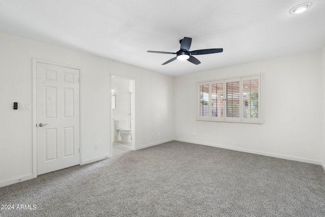 unfurnished bedroom with carpet flooring, ensuite bathroom, and ceiling fan