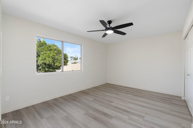 empty room with light hardwood / wood-style floors and ceiling fan