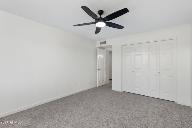 unfurnished bedroom with a closet, carpet floors, and ceiling fan