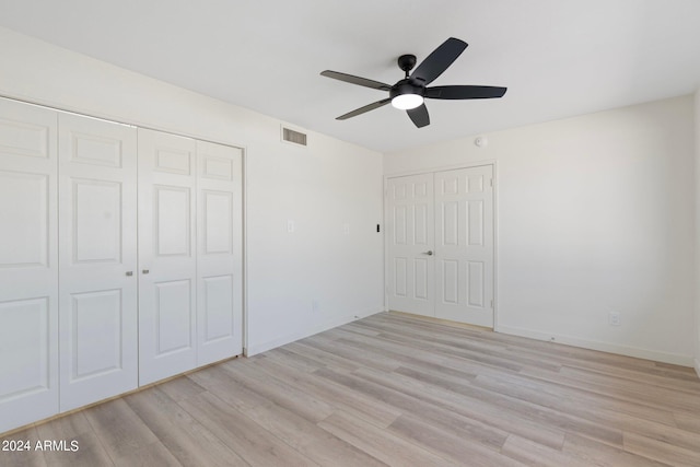 unfurnished bedroom with ceiling fan and light wood-type flooring