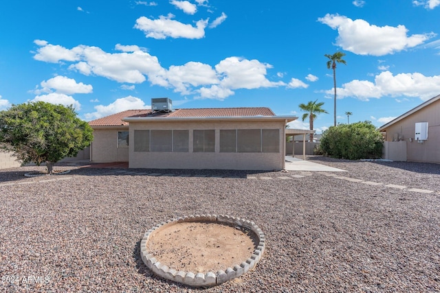 back of property featuring a patio, central air condition unit, and a sunroom