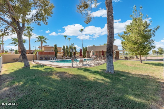 view of yard featuring a patio area and a fenced in pool