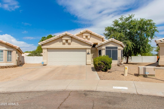 16642 N 35th Way, Phoenix, AZ 85032 - view of front of house with driveway, a garage, stucco siding, a tile roof, and fence