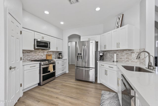 18132 W Cardinal Dr, Goodyear, AZ 85338 - kitchen with appliances with stainless steel finishes, light countertops, white cabinetry, backsplash, and recessed lighting