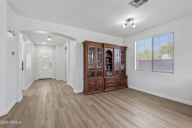 18132 W Cardinal Dr, Goodyear, AZ 85338 - entryway with arched walkways and light wood-style flooring
