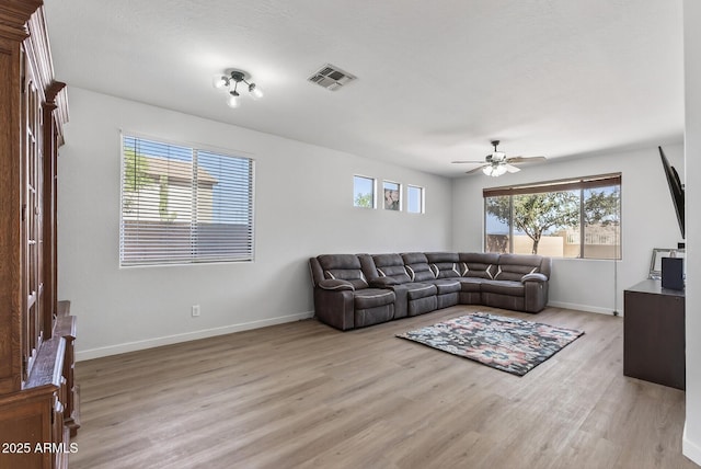18132 W Cardinal Dr, Goodyear, AZ 85338 - living area featuring light wood-style flooring and a ceiling fan