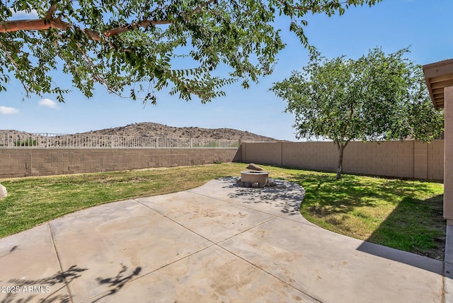 18132 W Cardinal Dr, Goodyear, AZ 85338 - fenced backyard featuring an outdoor fire pit and a patio area