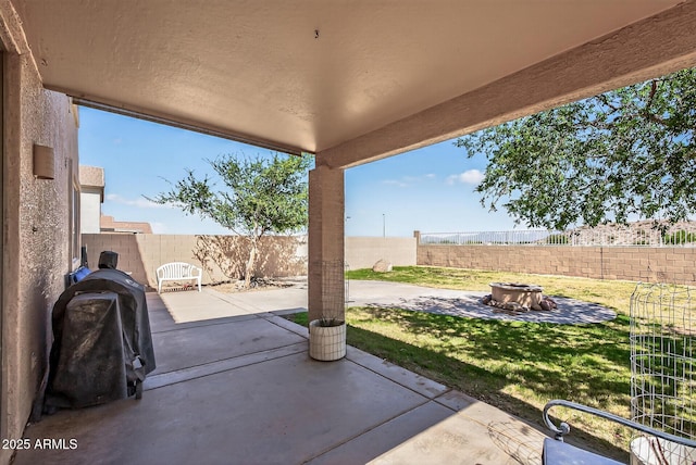 18132 W Cardinal Dr, Goodyear, AZ 85338 - fenced backyard featuring a fire pit, a patio, and area for grilling