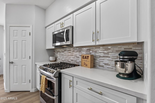 18132 W Cardinal Dr, Goodyear, AZ 85338 - kitchen featuring appliances with stainless steel finishes, tasteful backsplash, and light countertops
