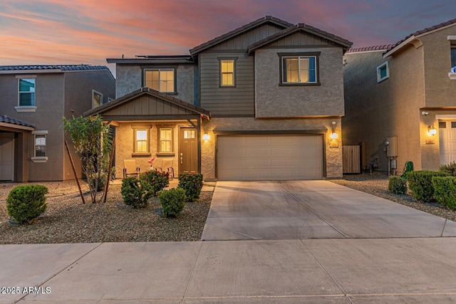 view of front facade with driveway, a garage, and stucco siding
