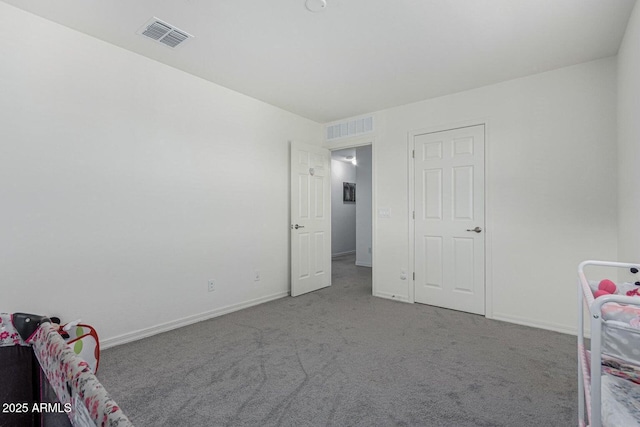 bedroom with visible vents, carpet flooring, and baseboards