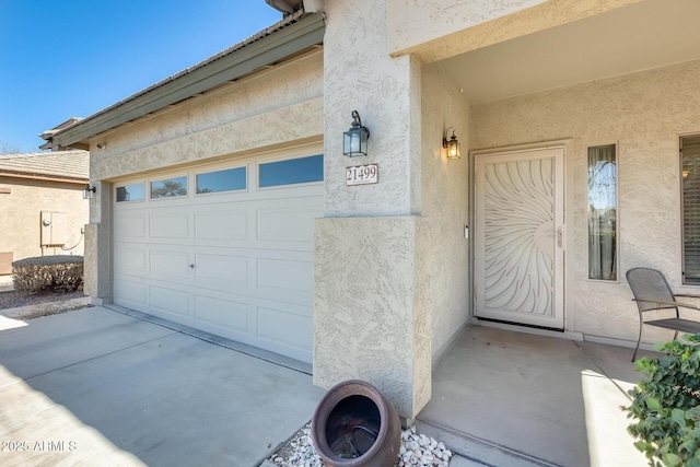 doorway to property with a garage