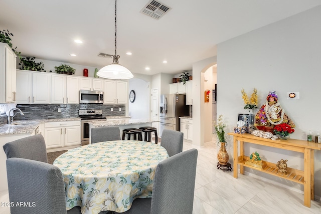 dining room featuring sink