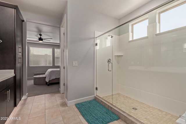 full bathroom featuring a stall shower, connected bathroom, vanity, baseboards, and tile patterned floors