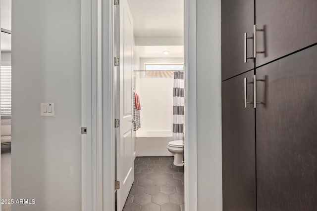 bathroom with toilet, shower / bath combo, and tile patterned floors