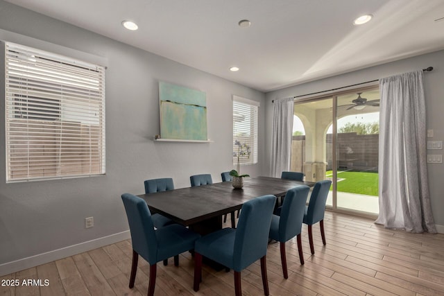 dining room with light wood finished floors, baseboards, and recessed lighting