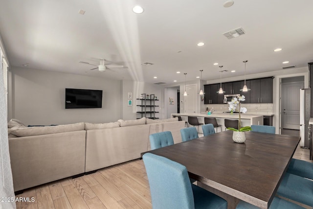 dining area with light wood-style flooring, visible vents, a ceiling fan, and recessed lighting