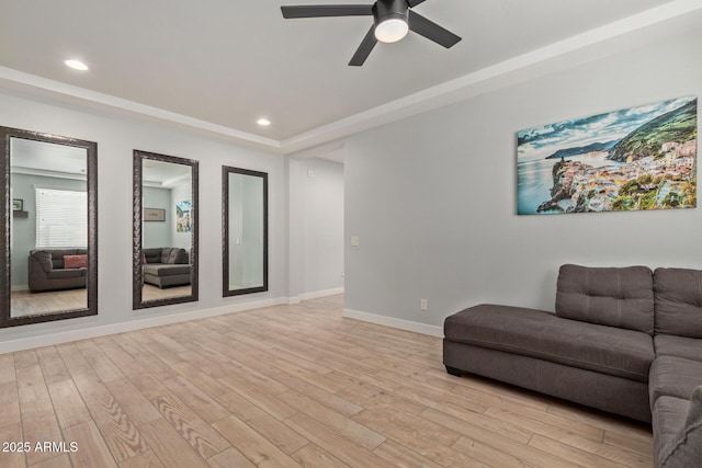 living area with light wood-type flooring, baseboards, a ceiling fan, and recessed lighting